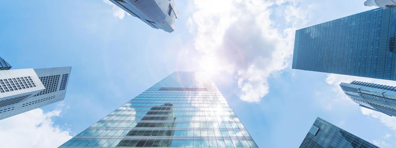 skyscrapers against blue sky and clouds